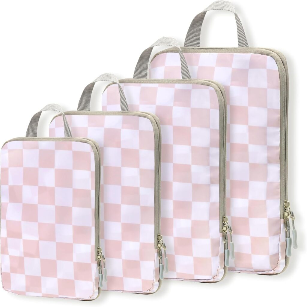 Four rectangular packing cubes with pink and white checkerboard patterns, gray zippers, and beige handles, arranged in a row from smallest to largest.