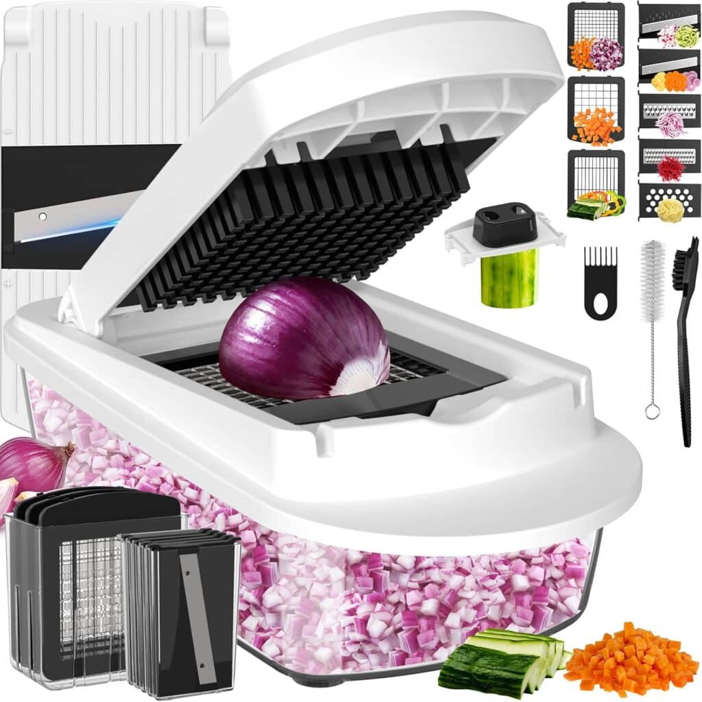 A white vegetable chopper with a lid and grid blade chops a red onion into small cubes. Surrounding the chopper are interchangeable blades, a cleaning brush, and other kitchen accessories. Diced onions and cucumbers are visible.