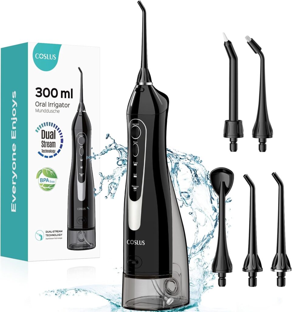 A black COSLUS 300 ml oral irrigator with four interchangeable nozzles is shown with water splashing around it. The product box is visible in the background, displaying features like "Dual Stream" and "BPA Free.