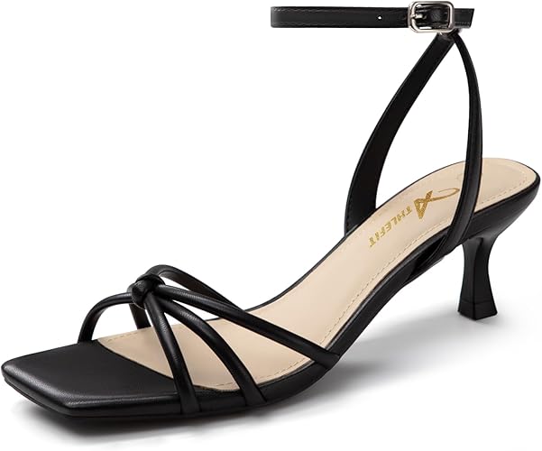 A black strappy heeled sandal with a square toe, ankle strap with buckle, low kitten heel, and light beige insole.