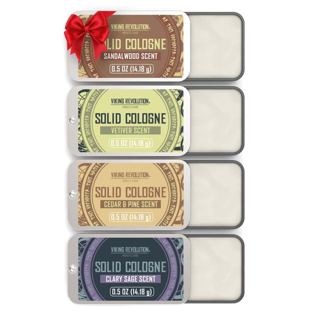 Four tins of Viking Revolution solid cologne in different scents (sandalwood, vetiver, cedar & pine, clary sage) are shown, one with a red bow. Each tin is open, displaying the solid cologne inside.