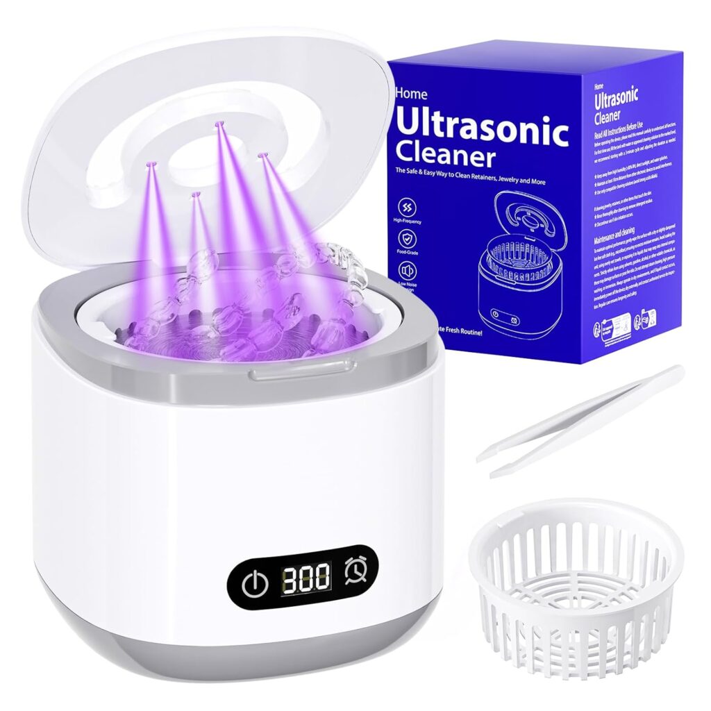 A white ultrasonic cleaner with an open lid emits purple light, displaying a digital timer at 300 seconds. Beside it are a white basket, tweezers, and the blue product box labeled “Home Ultrasonic Cleaner.”.