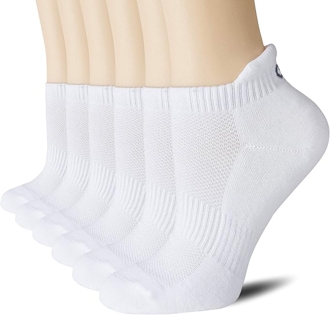 Six white ankle socks displayed on mannequin feet, aligned side by side, showing ribbed cuffs and textured fabric details.