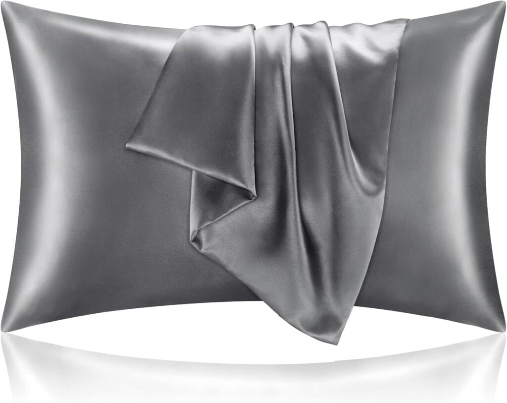 A smooth silver-gray satin pillowcase with a matching satin fabric draped over it, displayed against a white background.