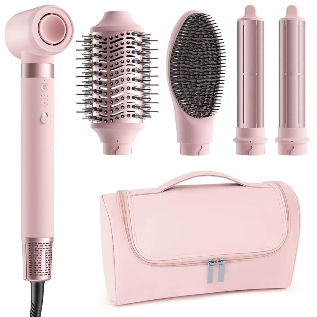 A pink multifunctional hair styling set featuring a hair dryer handle, round brush, paddle brush, two curling attachments, and a matching zippered storage bag.