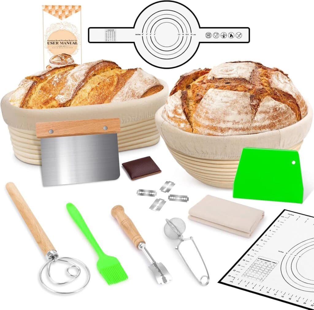 Baking kit with two round loaves in banneton baskets, a dough scraper, green brush, whisk, scoring tool, measuring spoons, baking mat, user manual, and other bread-making tools arranged neatly.