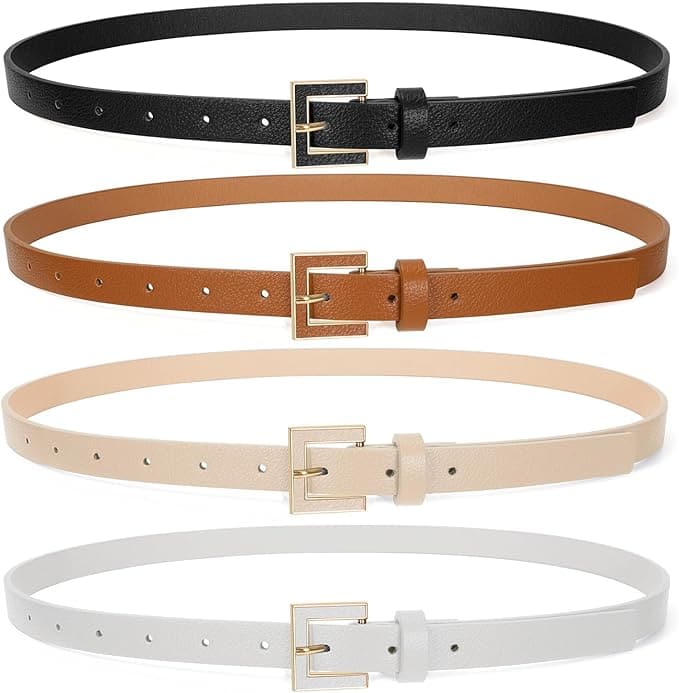 Four slim leather belts in black, brown, beige, and white, each with a gold rectangular buckle, are displayed horizontally in a row against a white background.