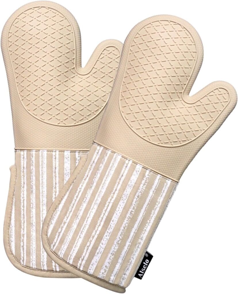 A pair of beige oven mitts with textured silicone grip on the hand area and vertical white and beige stripes on the cuff section, displayed side by side.