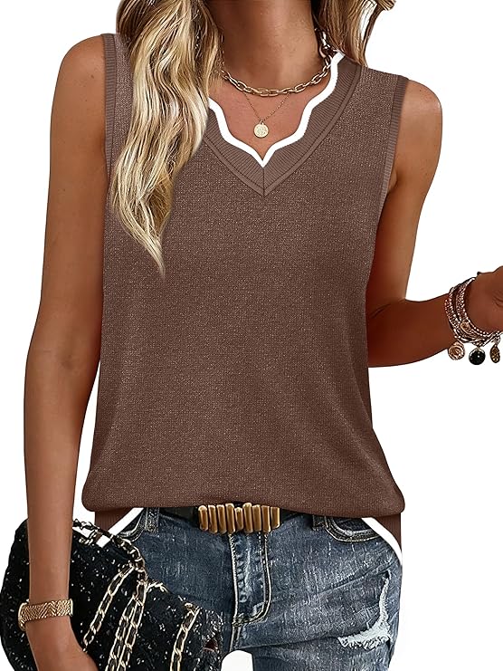 A woman wearing a sleeveless brown knit V-neck top with white trim, blue jeans, gold jewelry, and holding a black textured clutch. She has long wavy blonde hair and a casual-chic style.