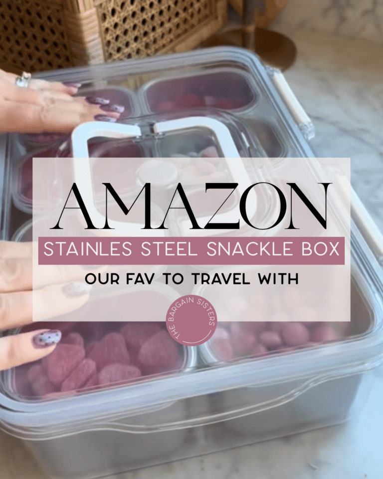 A person with painted nails places a clear-lidded Stainless Steel Snackle Box filled with berries on a counter. Text overlay reads: "Amazon Stainless Steel Snackle Box - Our fav to travel with.