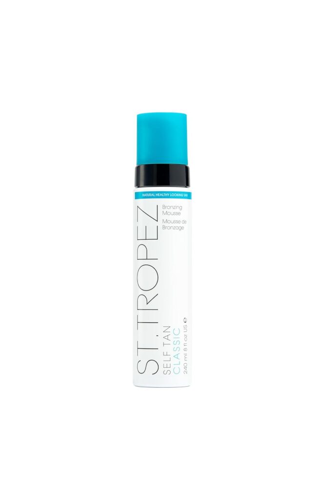 A white bottle of St. Tropez Self Tan Classic Bronzing Mousse with a turquoise cap and label, standing upright against a plain white background.