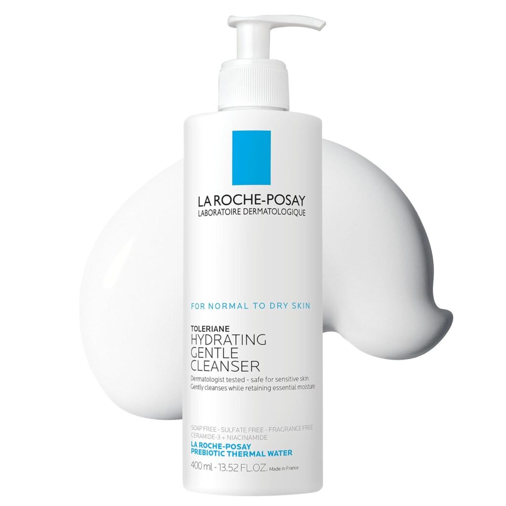 A white pump bottle of La Roche-Posay Toleriane Hydrating Gentle Cleanser with blue and black text, positioned in front of a dollop of white creamy cleanser on a white background.