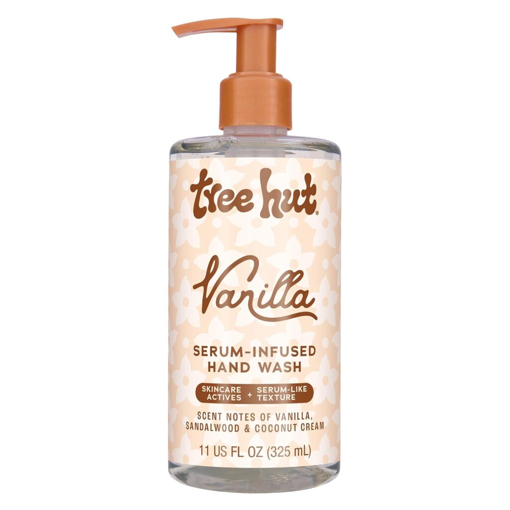 A bottle of Tree Hut Vanilla Serum-Infused Hand Wash with a pump dispenser. The beige label features white floral patterns and brown text highlighting vanilla scent and skincare actives. Grab this 11 fl oz (325 mL) essential during Thursday Deals!.