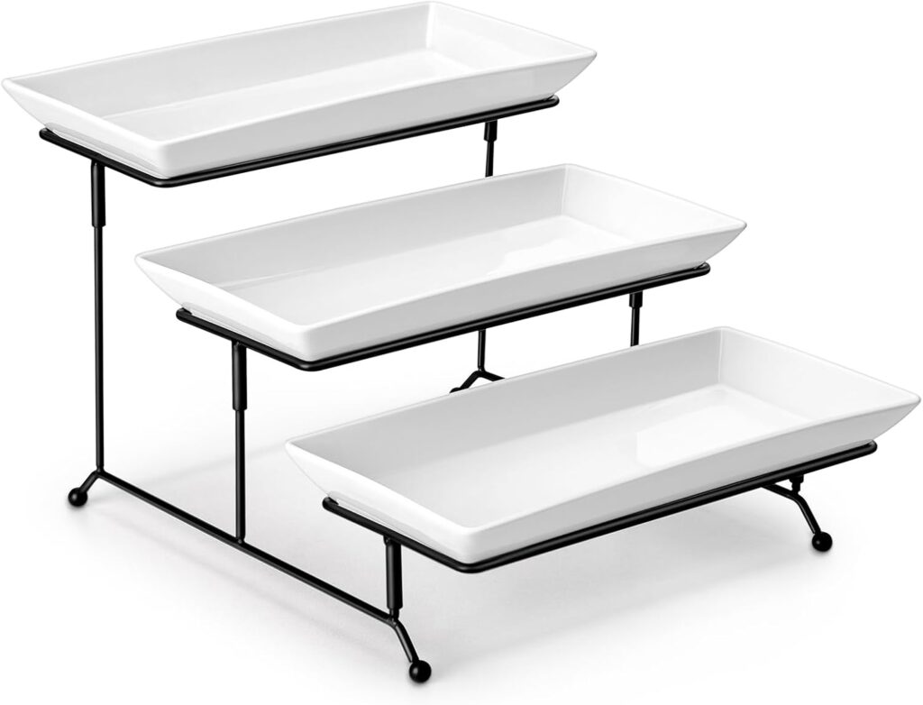 Three rectangular white ceramic serving trays displayed on a black metal tiered stand, with each tray positioned at a different height to create a stepped arrangement.