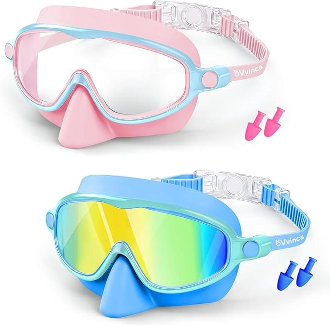 This 2 Pack of Kids Swim Goggles includes one pink pair with clear lenses and one blue pair with mirrored lenses, each featuring a matching nose cover, adjustable strap, and a set of earplugs beside each mask.