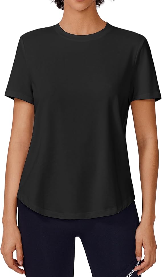 A person wearing a plain black short-sleeve t-shirt and dark leggings stands facing forward against a white background. The t-shirt has a round neckline and a relaxed fit.