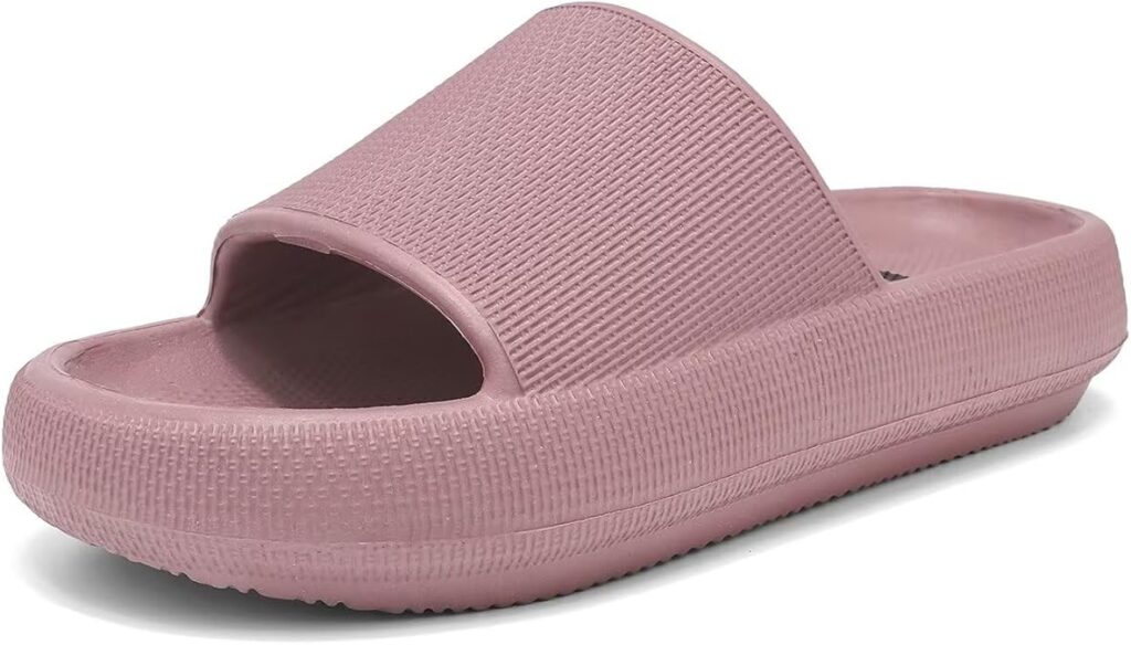 A single pink slide sandal with a thick rubber sole and textured upper strap, shown on a white background.