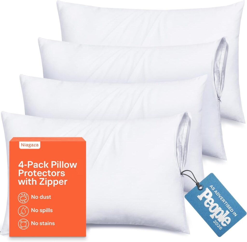 Four white pillow protectors with zippers are arranged in a row, with an orange box labeled “4-Pack Pillow Protectors with Zipper” in front. A blue tag is attached to one protector, stating "As advertised in People 2020.