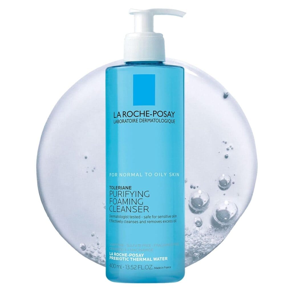 A blue pump bottle of La Roche-Posay Toleriane Purifying Foaming Cleanser stands before a foamy, translucent background. The label highlights it’s for normal to oily skin and contains 13.52 fl oz (400 ml). Great pick for Thursday Deals!.