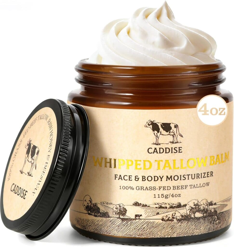 A brown jar labeled "Caddise Whipped Tallow Balm, Face & Body Moisturizer, 100% Grass-Fed Beef Tallow, 115g/4oz" with the lid off and white whipped balm swirled on top.