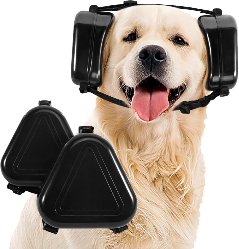A golden retriever wearing black noise-canceling ear muffs on its head, with an additional pair of the same ear muffs displayed in the foreground. The dog looks happy with its mouth open and tongue out.