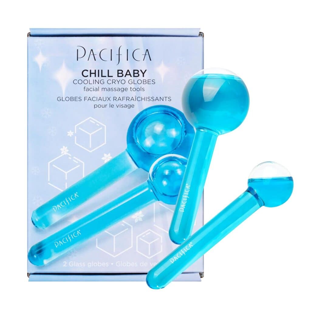 Blue Pacifica Chill Baby Cooling Cryo Globes facial massage tools are displayed in front of their product box, which is purple with white text and ice cube illustrations. Two glass globes are shown overlapping each other.