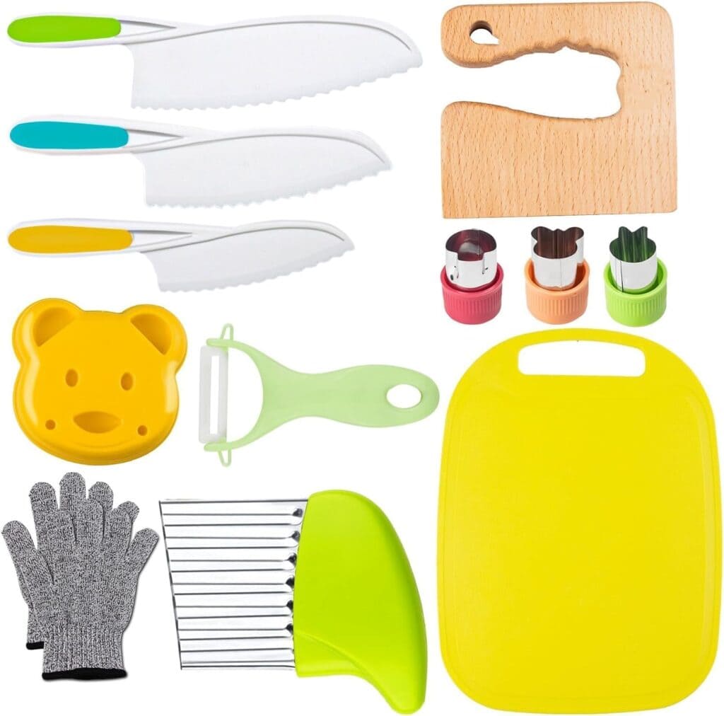 A set of colorful kitchen utensils including three knives, a wooden cutting board, fruit cutters, a bear-shaped sandwich cutter, a peeler, a yellow cutting board, a safety glove, and a crinkle cutter.