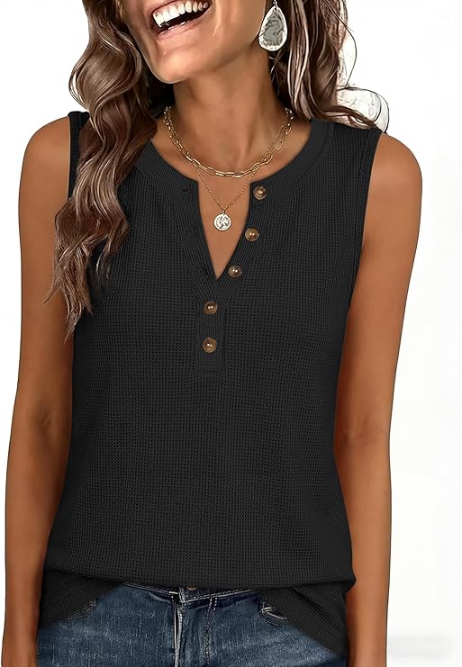 Smiling woman wearing a sleeveless black textured top with brown buttons, layered necklaces, earrings, and blue jeans—perfect for grabbing those Friday Deals in style.