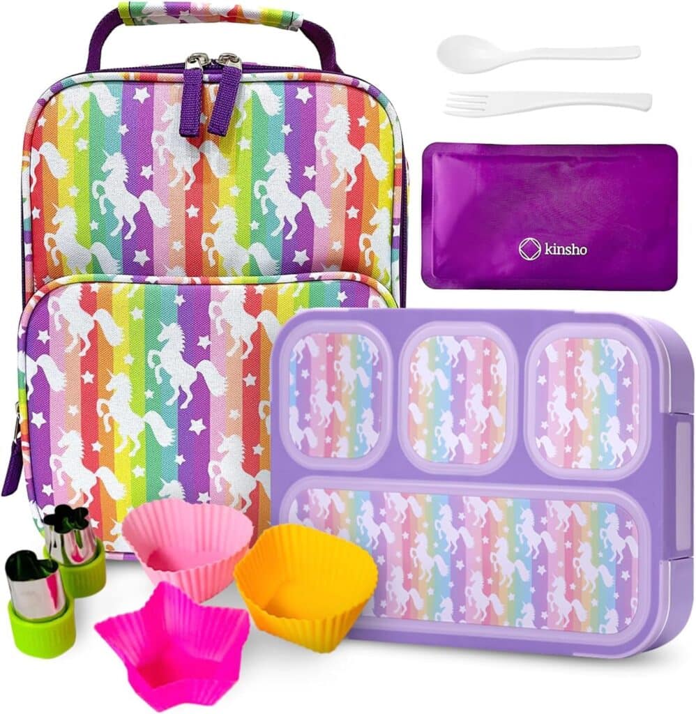 A colorful lunch set featuring a unicorn-patterned rainbow lunch bag, a purple bento box with matching unicorn design, a purple case with white utensils, and bright silicone cupcake liners—plus small veggie cutters. Perfect for Thursday Deals!.