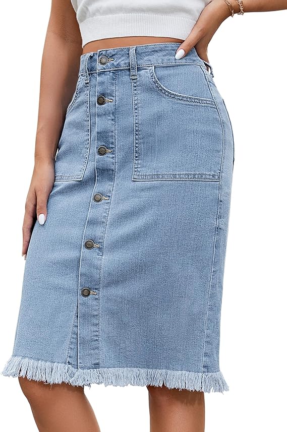 Woman wearing a light blue denim skirt with front buttons, large pockets, and a frayed hem. She is also wearing a white cropped top and a bracelet on her wrist.