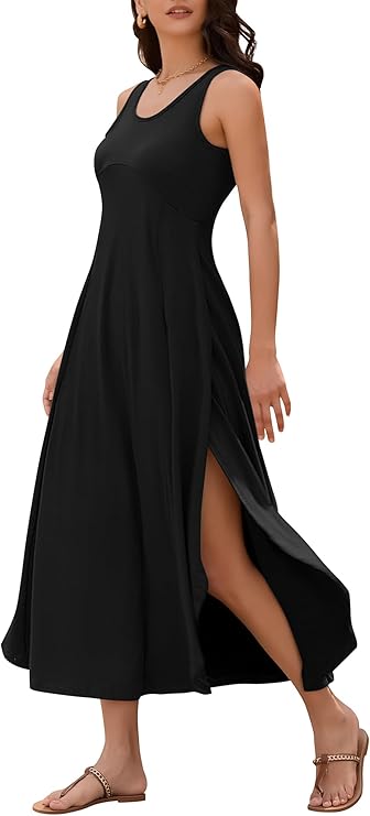 A woman wearing a flowy maxi dress with a side slit stands in sandals. This casual tank dress is sleeveless, black, and perfect for warm weather—now available at 56% off.