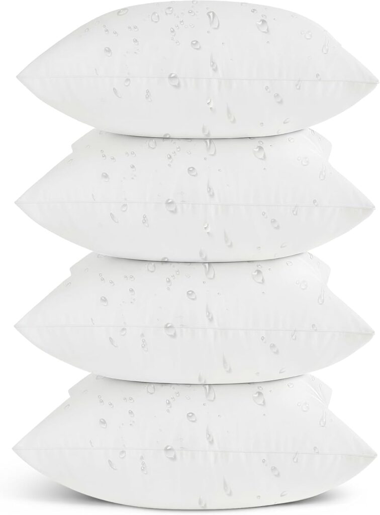 Four white pillows stacked on top of each other, each with visible water droplets highlighting their waterproof design. The plain white background keeps the focus on these premium pillows—perfect for grabbing with Tuesday Deals.