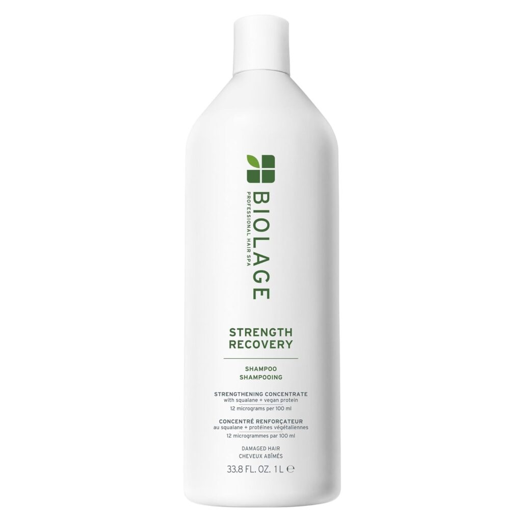 A white bottle of Biolage Strength Recovery Shampoo, part of the Premium Beauty collection, labeled as a strengthening concentrate for damaged hair, with green text and a 33.8 fl oz (1 liter) capacity.