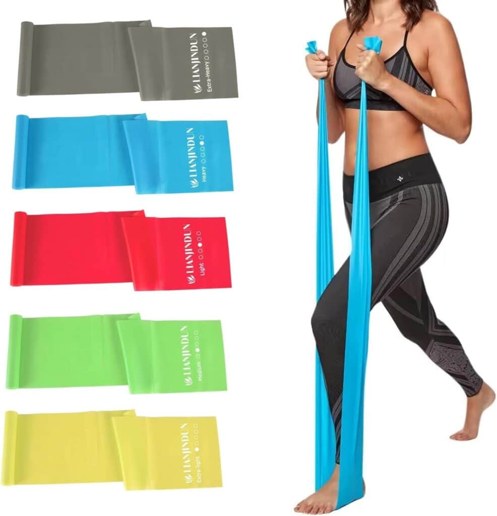 A woman in workout attire uses a blue resistance band. Next to her, five resistance bands in gray, blue, red, green, and yellow are displayed with their resistance levels—perfect for scoring great Monday Deals on your next fitness upgrade.
