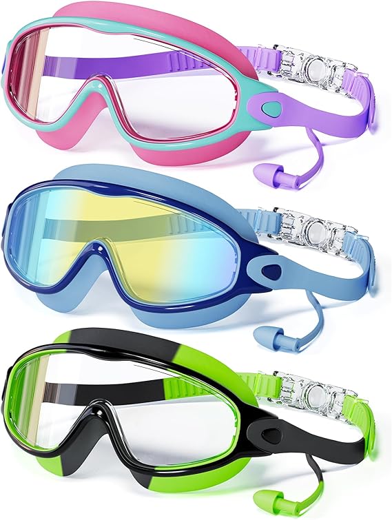 Three swim goggles in pink, blue, and black with green, each with a single wide lens and attached earplugs. The goggles have adjustable straps and are arranged vertically against a white background.