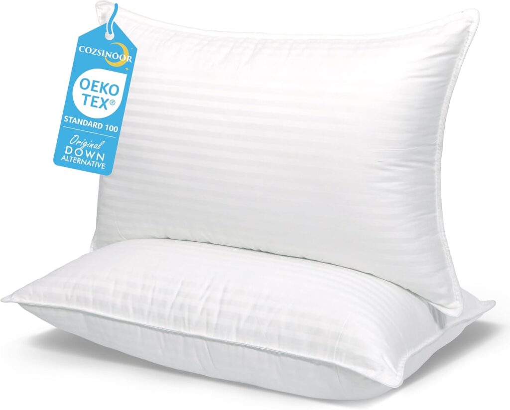 Two white, rectangular pillows with a subtle striped pattern are stacked. The top pillow features a blue "OEKO-TEX Standard 100" tag and "Original Down Alternative." Shop now to enjoy special Tuesday Deals on these cozy essentials.