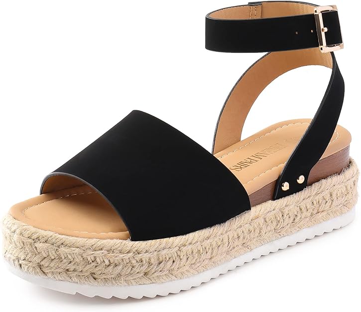 A single platform sandal with a black ankle strap, tan footbed, open toe, and thick espadrille-style woven sole—now available in Wednesday Deals—featuring a white textured outsole and gold buckle detail.