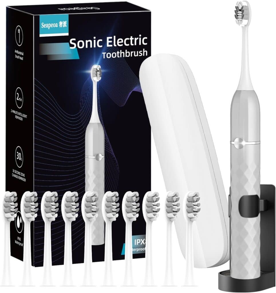 A white sonic electric toothbrush set with a charging stand, travel case, 8 replacement brush heads, and a black box labeled "Sonic Electric Toothbrush" featuring a blue wave design.