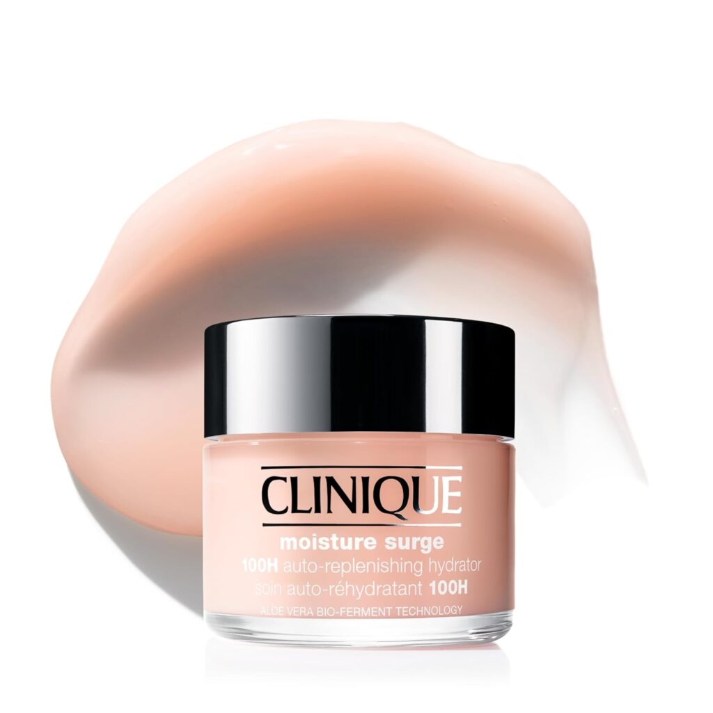 A jar of Clinique Moisture Surge 100H Auto-Replenishing Hydrator sits before a smooth, pale pink cream swirl, highlighting this premium beauty face moisturizer's luxurious texture and intense hydration benefits.