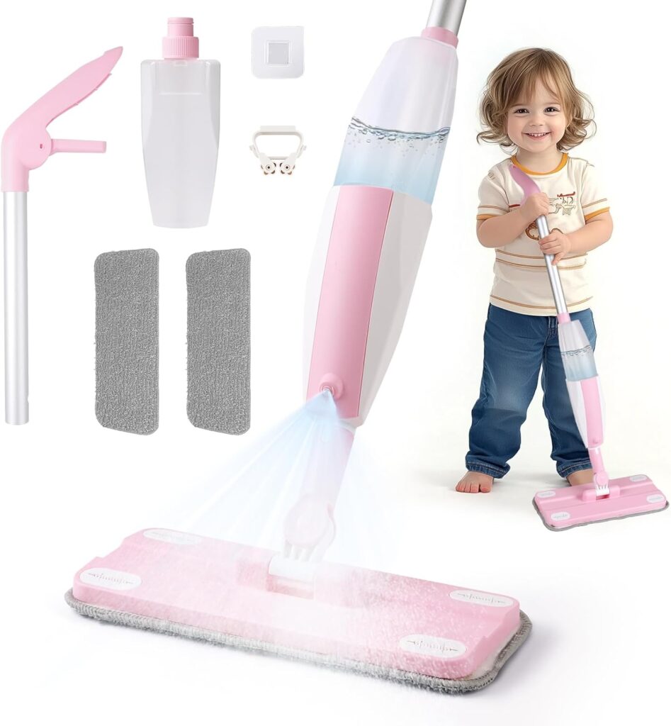A young child smiles while using a pink and white spray mop. The image also showcases Wednesday Deals on mop attachments, two gray cleaning pads, a spray bottle, and a white plastic clip arranged around the mop.