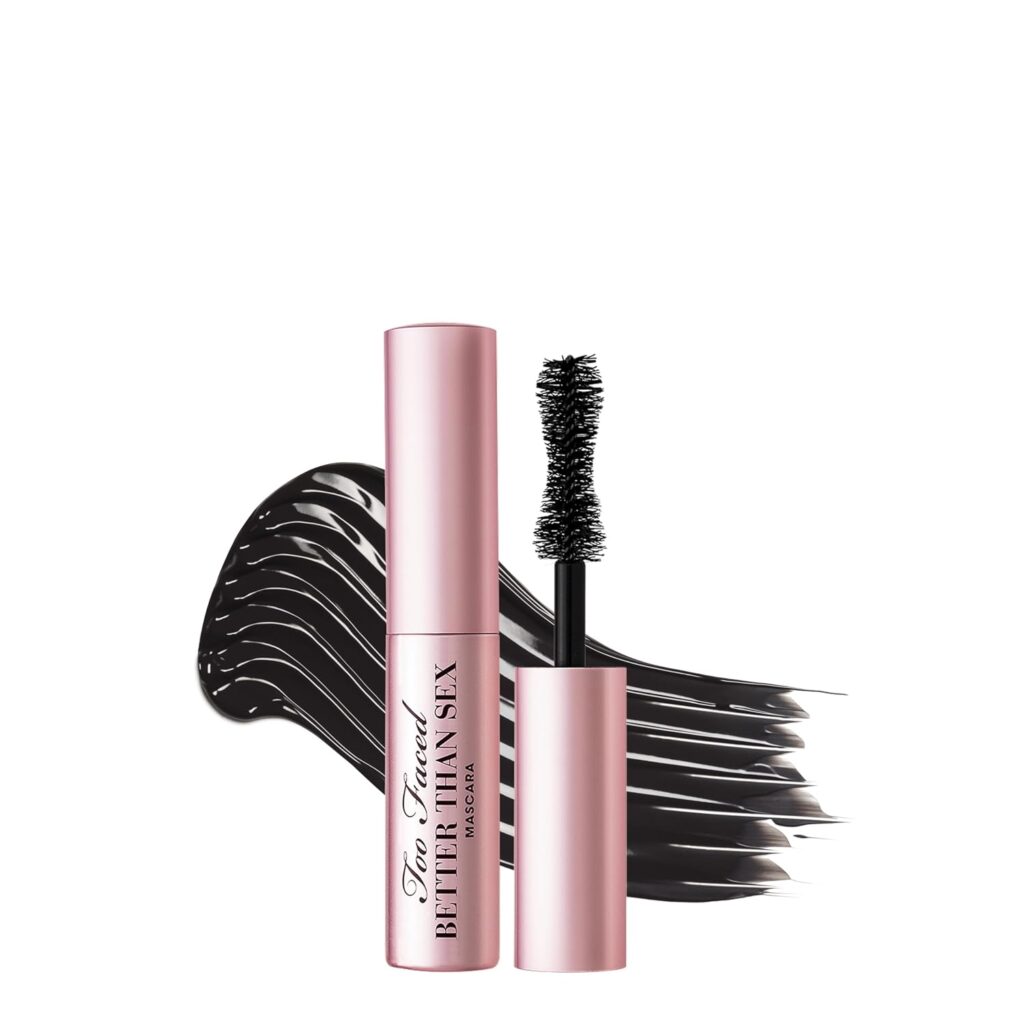 A pink tube of Too Faced Better Than Sex mascara is shown with the wand applicator beside it, in front of bold black mascara strokes on a white background—perfect for scoring Wednesday Deals.