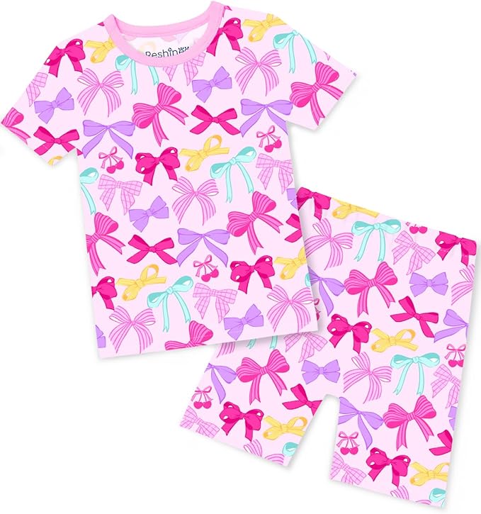 Children’s short-sleeve pajama set with a pink background, decorated with colorful bows in shades of pink, purple, and yellow. Shop this adorable shirt and shorts combo now and enjoy exclusive Tuesday Deals!.