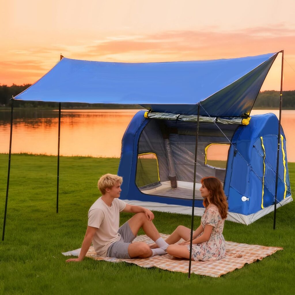 A young man and woman sit on a blanket near a blue tent with an awning by a lake at sunset, enjoying the orange and pink sky, green grass, and the peaceful vibe—perfect for making plans for Wednesday Deals.