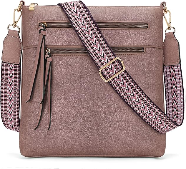 A mauve crossbody bag with two front zippered pockets, tassel zipper pulls, and a wide, adjustable chevron strap—perfect for snagging during our Friday Deals.