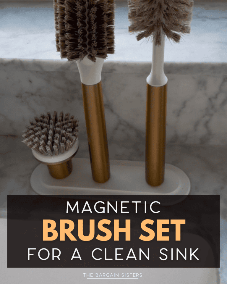 Three cleaning brushes with gold handles and brown bristles are attached magnetically to a matching stand on a marble countertop. Text overlay reads: "Magnetic Brush Set for a Clean Sink.