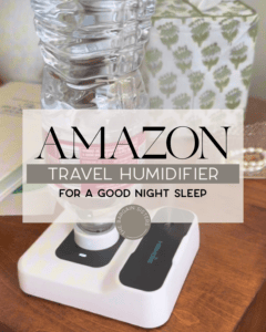 A compact travel humidifier with a water bottle attached, sitting on a bedside table next to a tissue box. Text overlay reads: "Amazon Travel Humidifier For A Good Night Sleep.