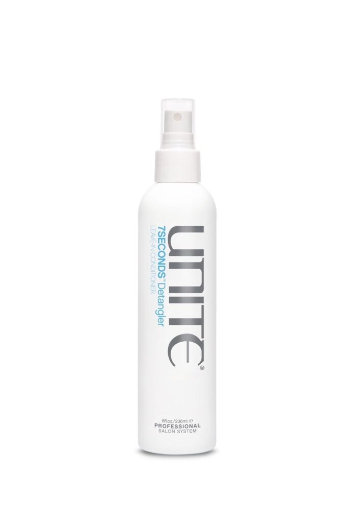 A white spray bottle of UNITE 7SECONDS Detangler with blue and silver text, featuring a clear cap, stands upright against a plain white background—perfect for grabbing in this week’s Monday Deals.
