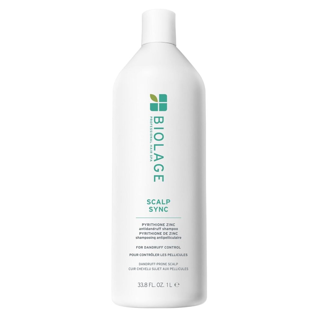 A white bottle of Biolage Scalp Sync shampoo with green and teal text, featuring a flip-top cap. This Premium Beauty product highlights pyrithione zinc for dandruff control and has a volume of 33.8 fl oz (1 L).
