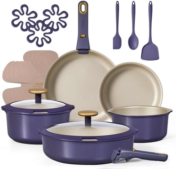 A 14-piece nonstick cookware set in purple with gold accents, perfect for Monday Deals. Includes pots with lids, pans, a detachable handle, spatulas, pan protectors, and flower-shaped silicone trivets—all displayed against a white background.