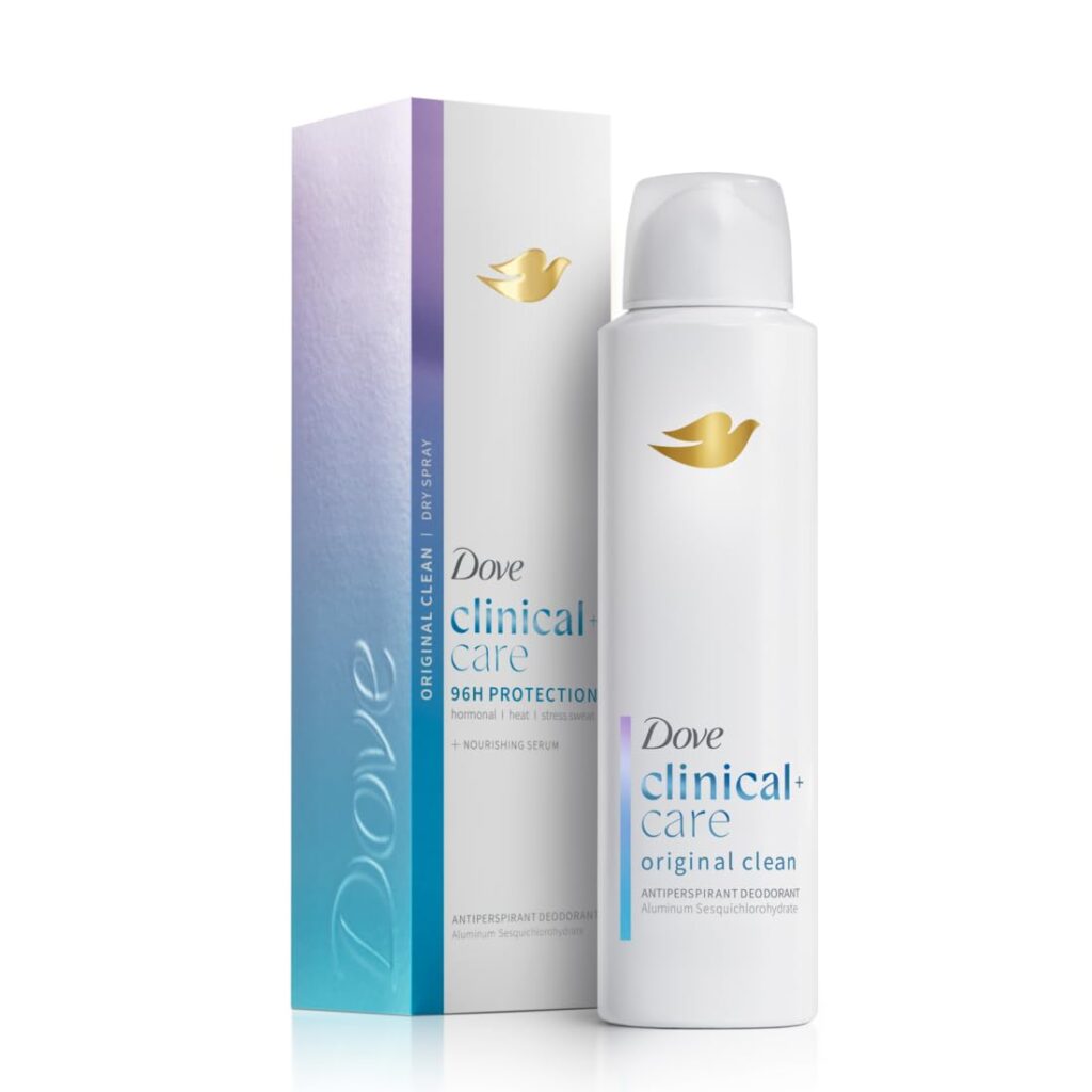A Dove Clinical+ Care Original Clean antiperspirant deodorant spray can stands next to its matching box, featuring a minimalist white and purple design with the gold Dove logo—perfect for refreshing your routine with exclusive Wednesday Deals.